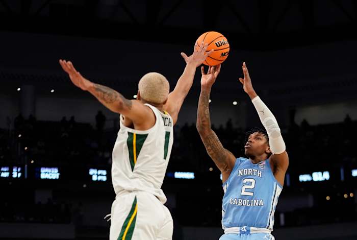 North Carolina Tar Heels guard Caleb Love (2) shoots over Baylor Bears forward Jeremy Sochan (1) during the second round of the 2022 NCAA Tournament at Dickies Arena.